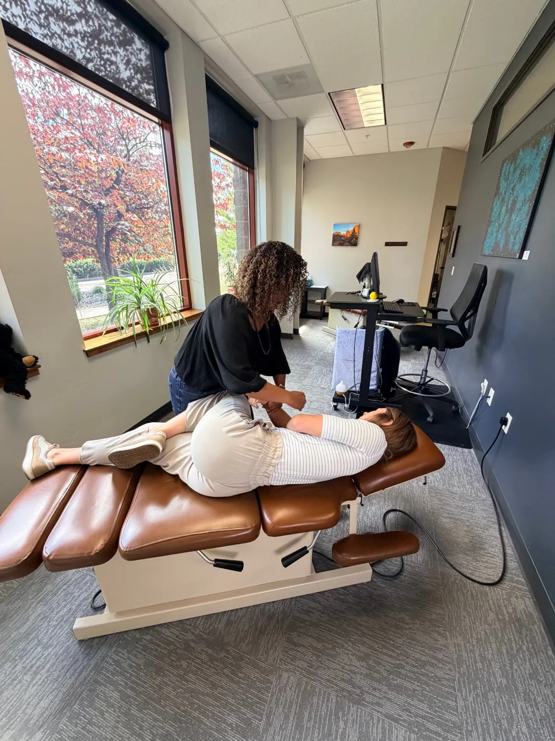 A Point Chiropractic chiropractor performing a side-lying adjustment on a patient on a treatment table