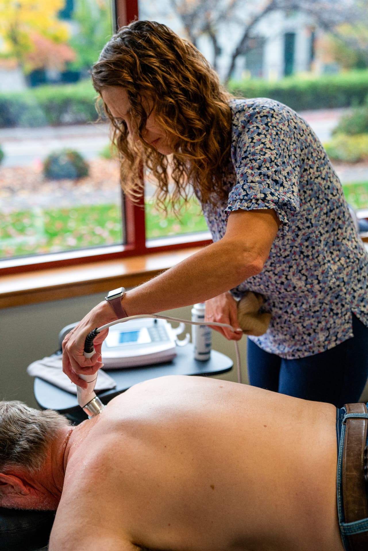 Clinician applying therapeutic ultrasound to a patient's lower back